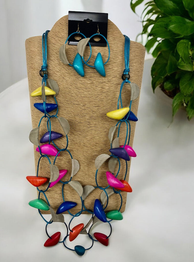 A vibrant luxury necklace set with multicolored beads displayed on a wooden mannequin bust.