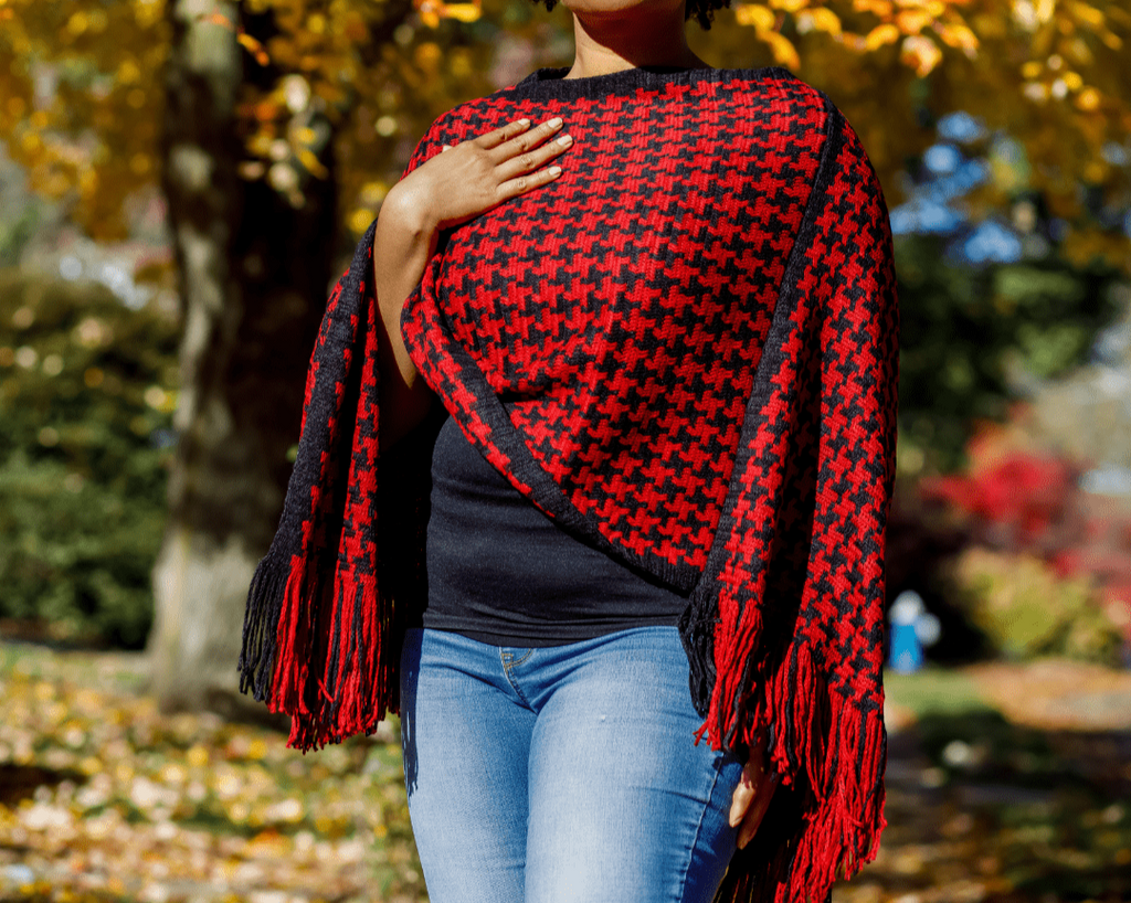 This is a one size fits most red and black houndstooth poncho. Sits right at at the waist and just the right touch of fringe on part of the hem.