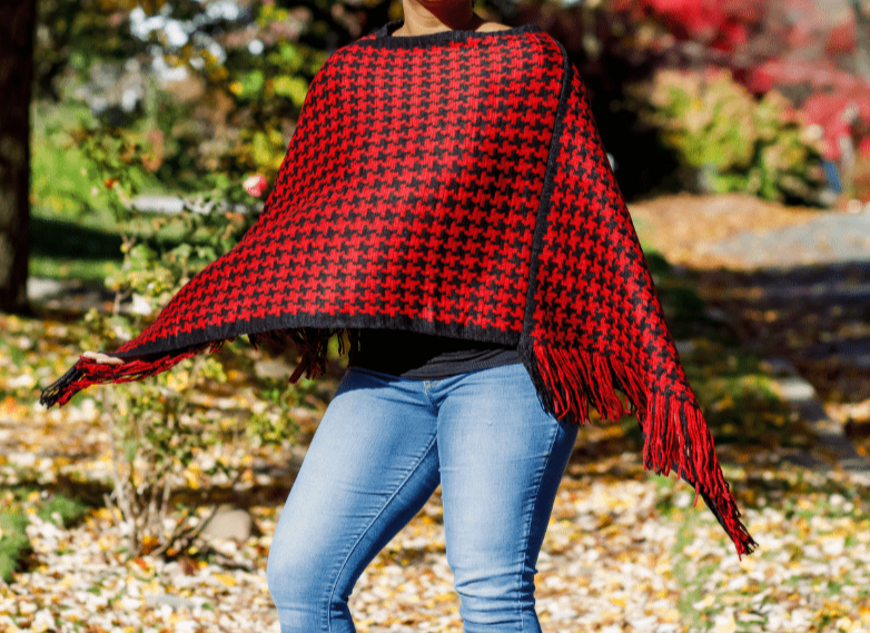 This is a one size fits most red and black houndstooth poncho. Sits right at at the waist and just the right touch of fringe on part of the hem.
